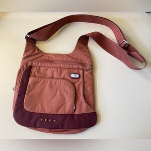 Orange Tumi crossbody bag